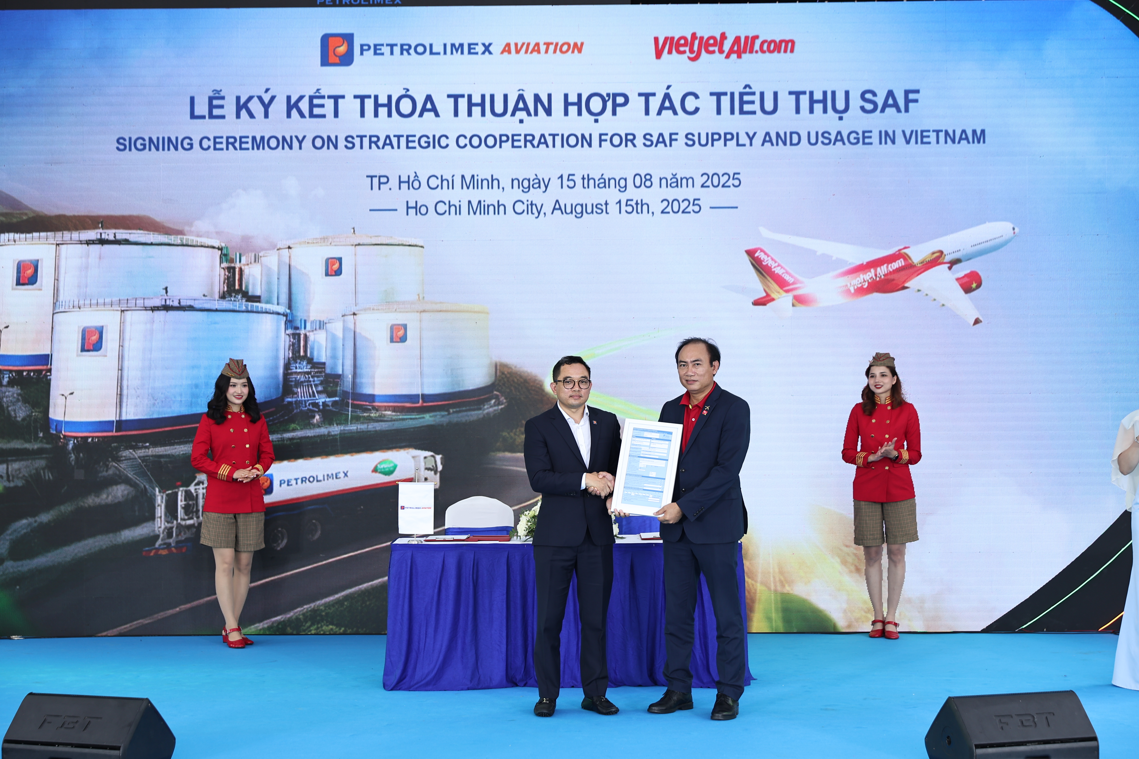 A person holding a certificate and a person standing behind himAI-generated content may be incorrect.